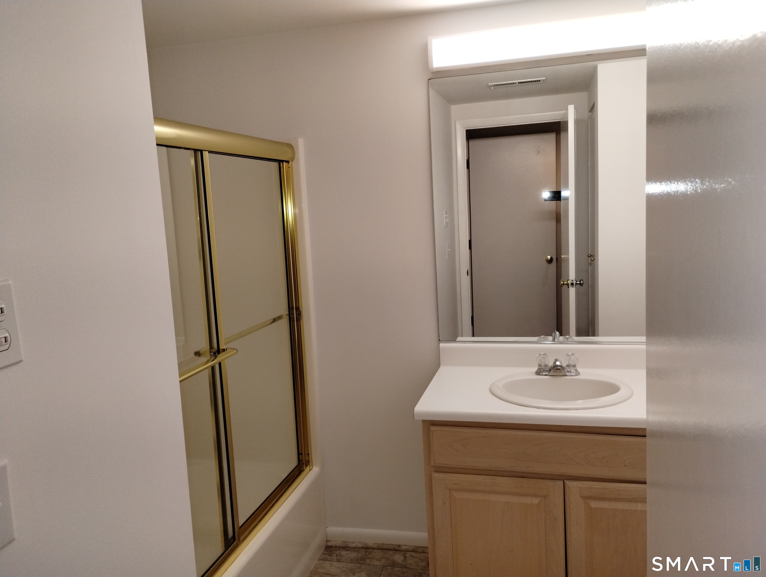 523 Popes Island Road, Unit 523 Milford, CT 06461 - Photo 12 of 33 a bathroom with a sink a mirror and a vanity