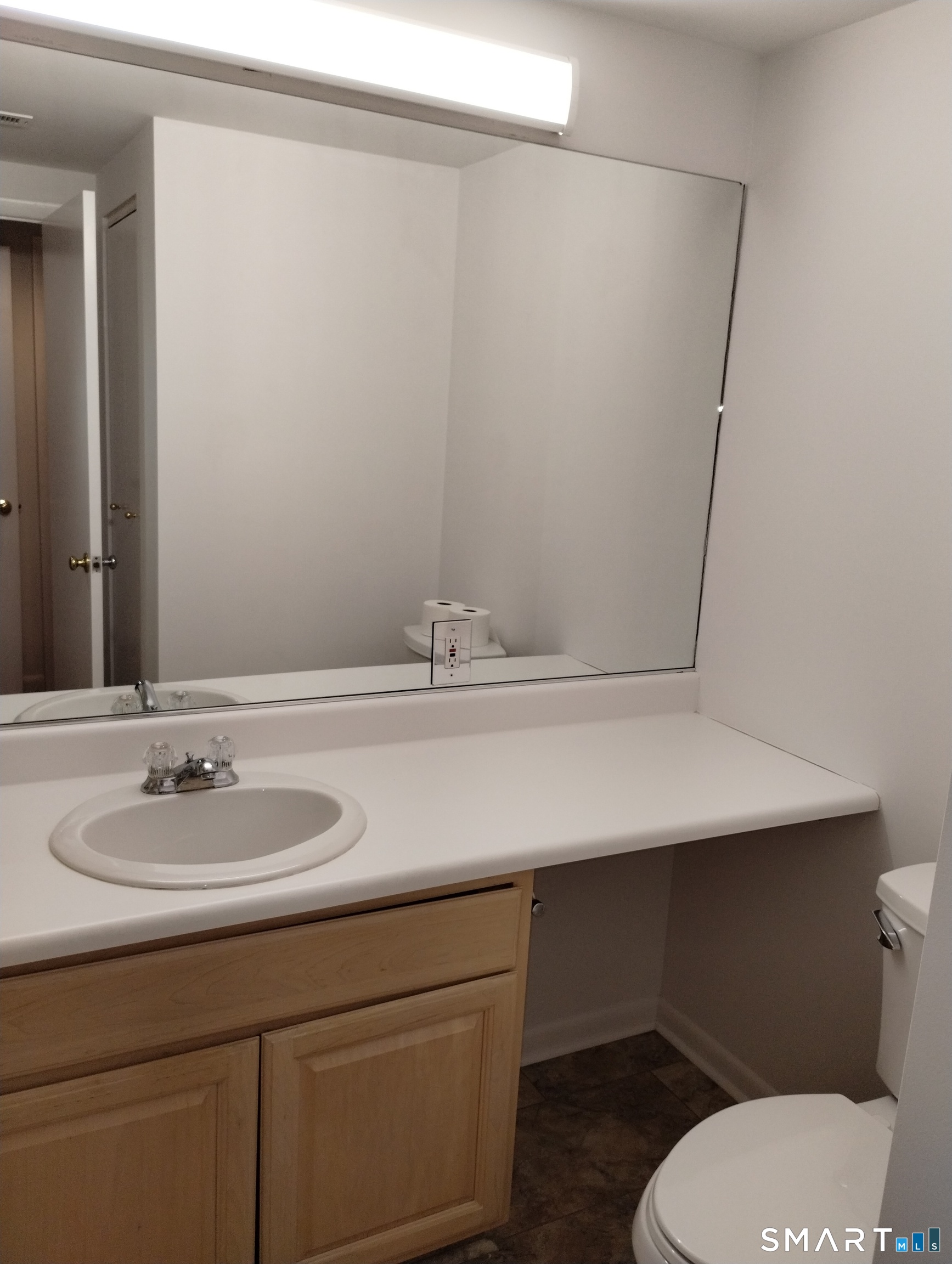 523 Popes Island Road, Unit 523 Milford, CT 06461 - Photo 13 of 33 a bathroom with a sink toilet and mirror
