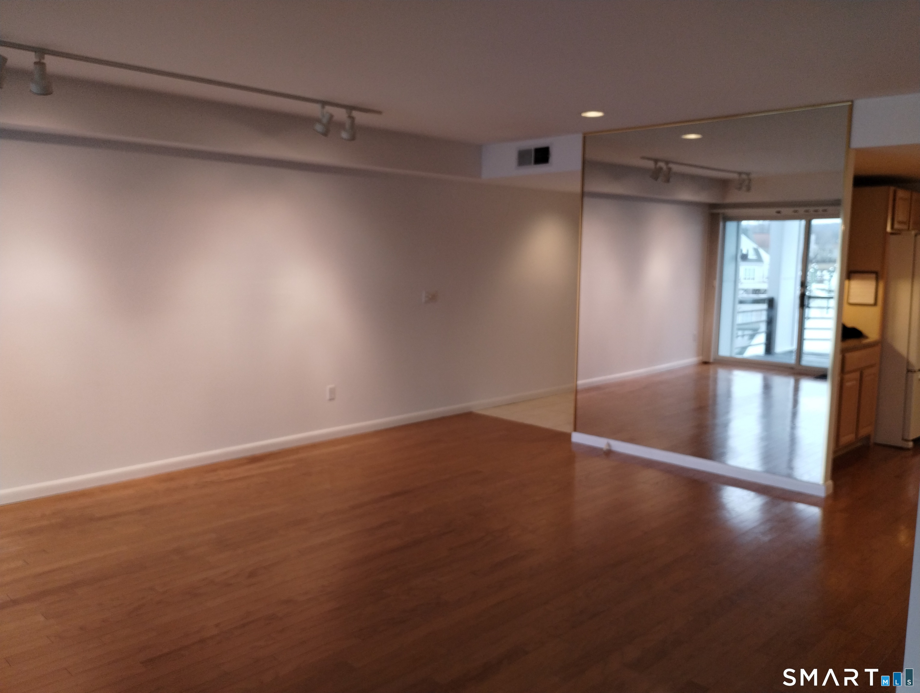 523 Popes Island Road, Unit 523 Milford, CT 06461 - Photo 17 of 33 a view of empty room with wooden floor
