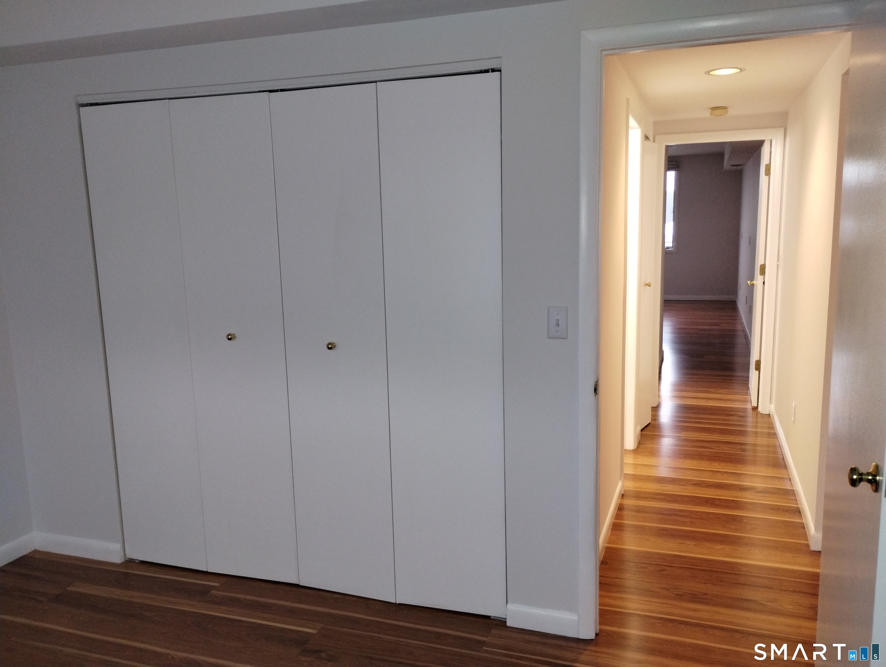 523 Popes Island Road, Unit 523 Milford, CT 06461 - Photo 20 of 33 a view of a hallway with wooden floor