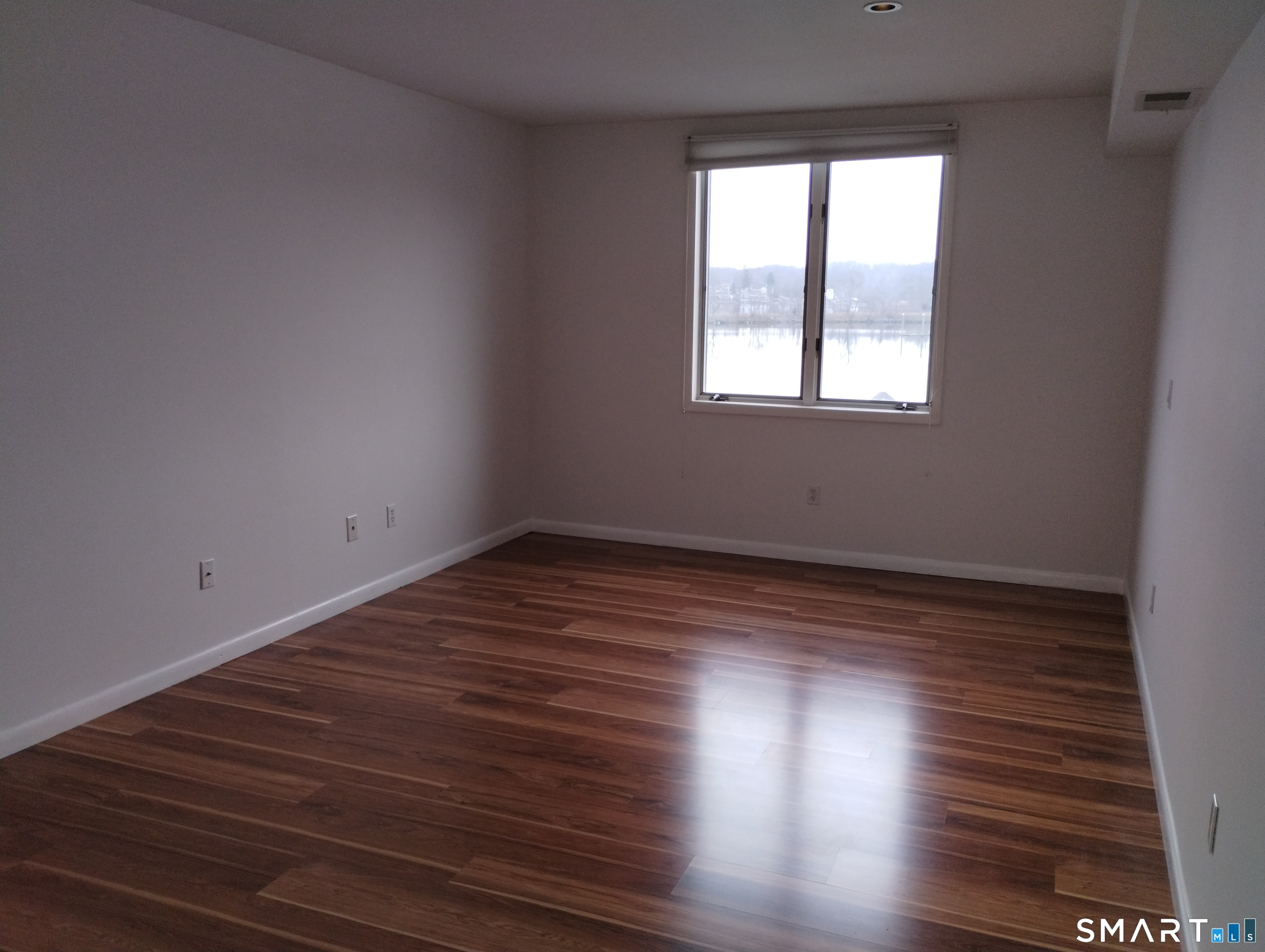 523 Popes Island Road, Unit 523 Milford, CT 06461 - Photo 21 of 33 a view of a room with wooden floors and window