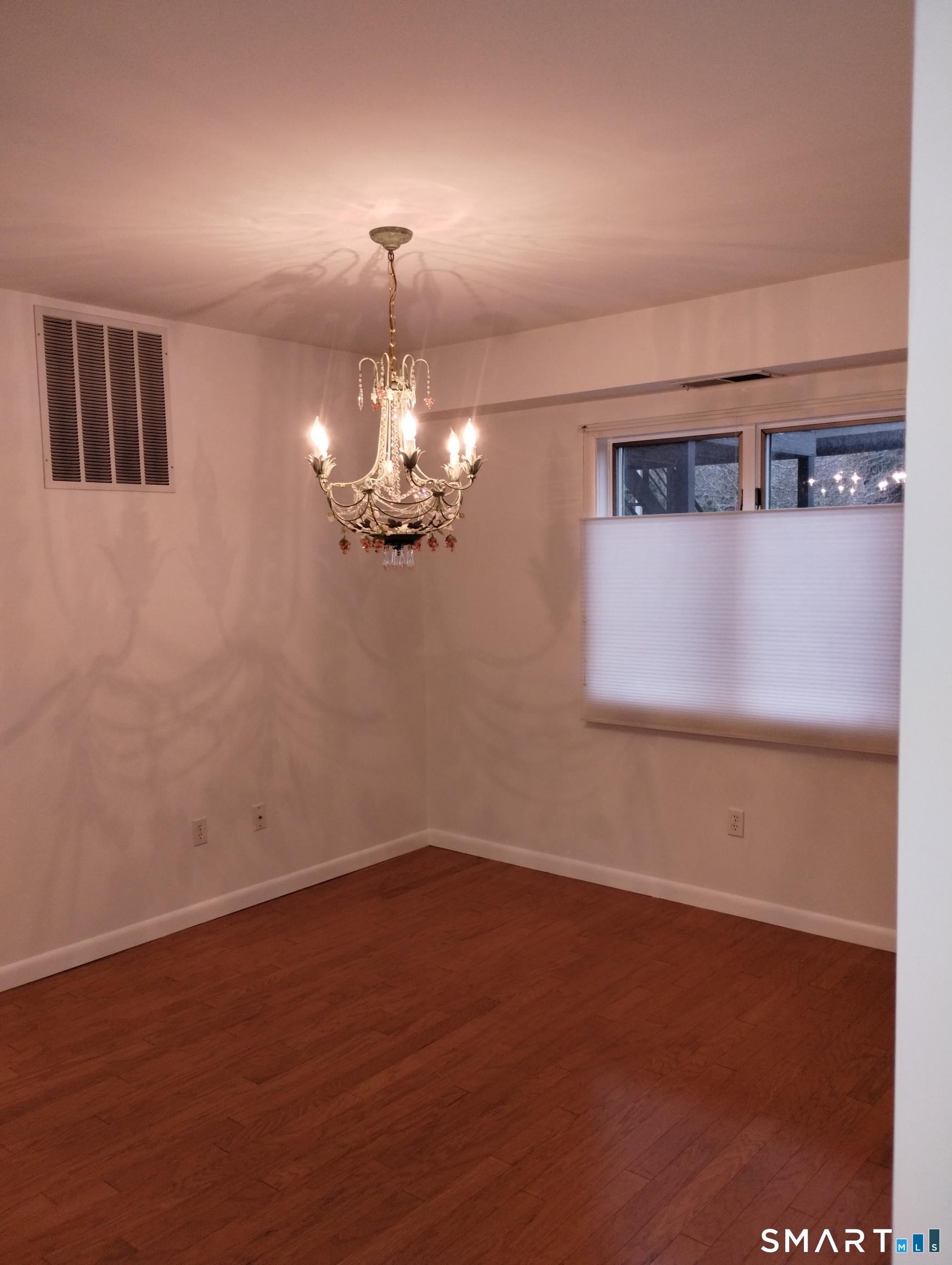 523 Popes Island Road, Unit 523 Milford, CT 06461 - Photo 24 of 33 a view of a room with a chandelier fan and wooden floor