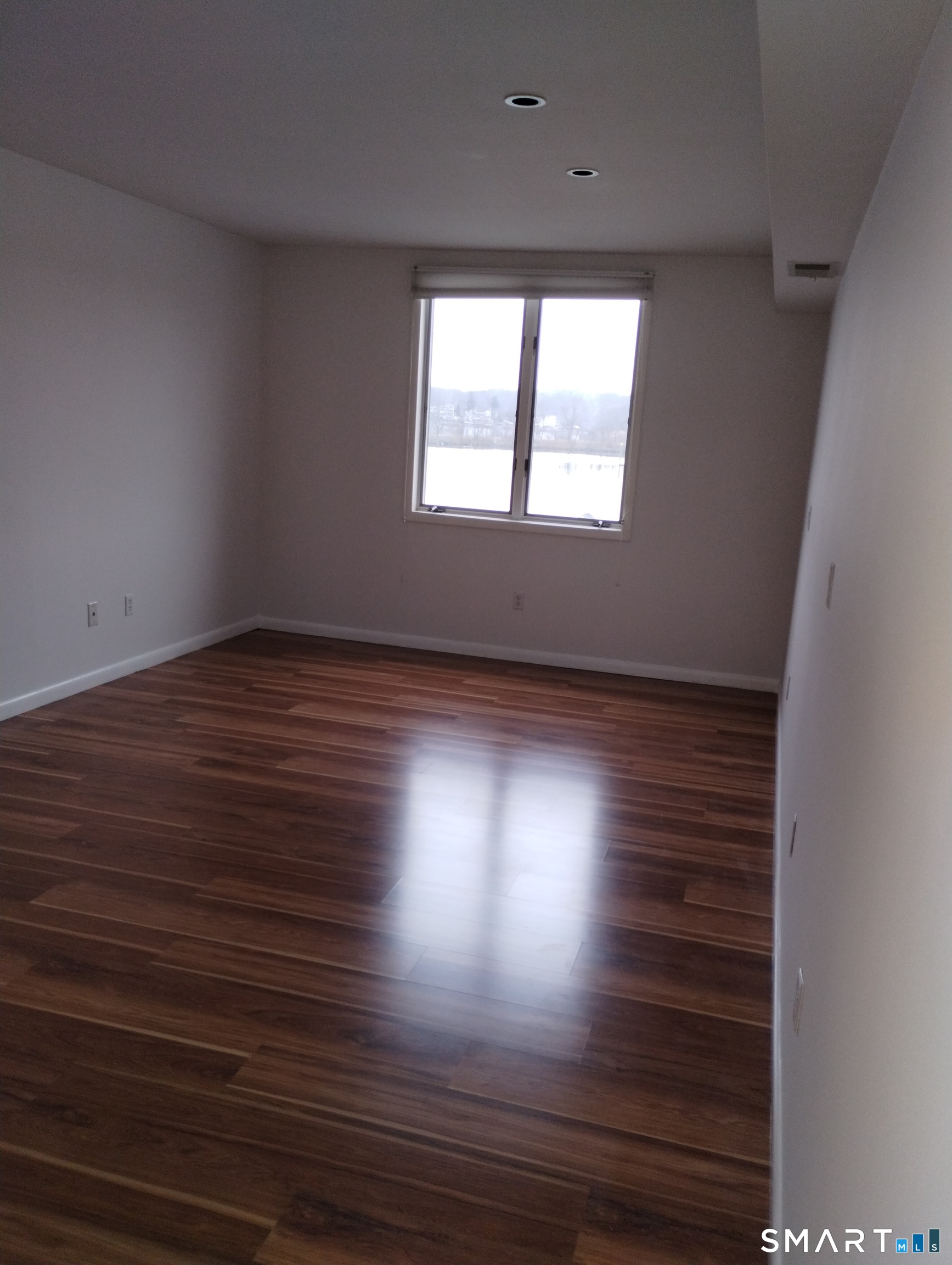 523 Popes Island Road, Unit 523 Milford, CT 06461 - Photo 28 of 33 a view of empty room with wooden floor and fan