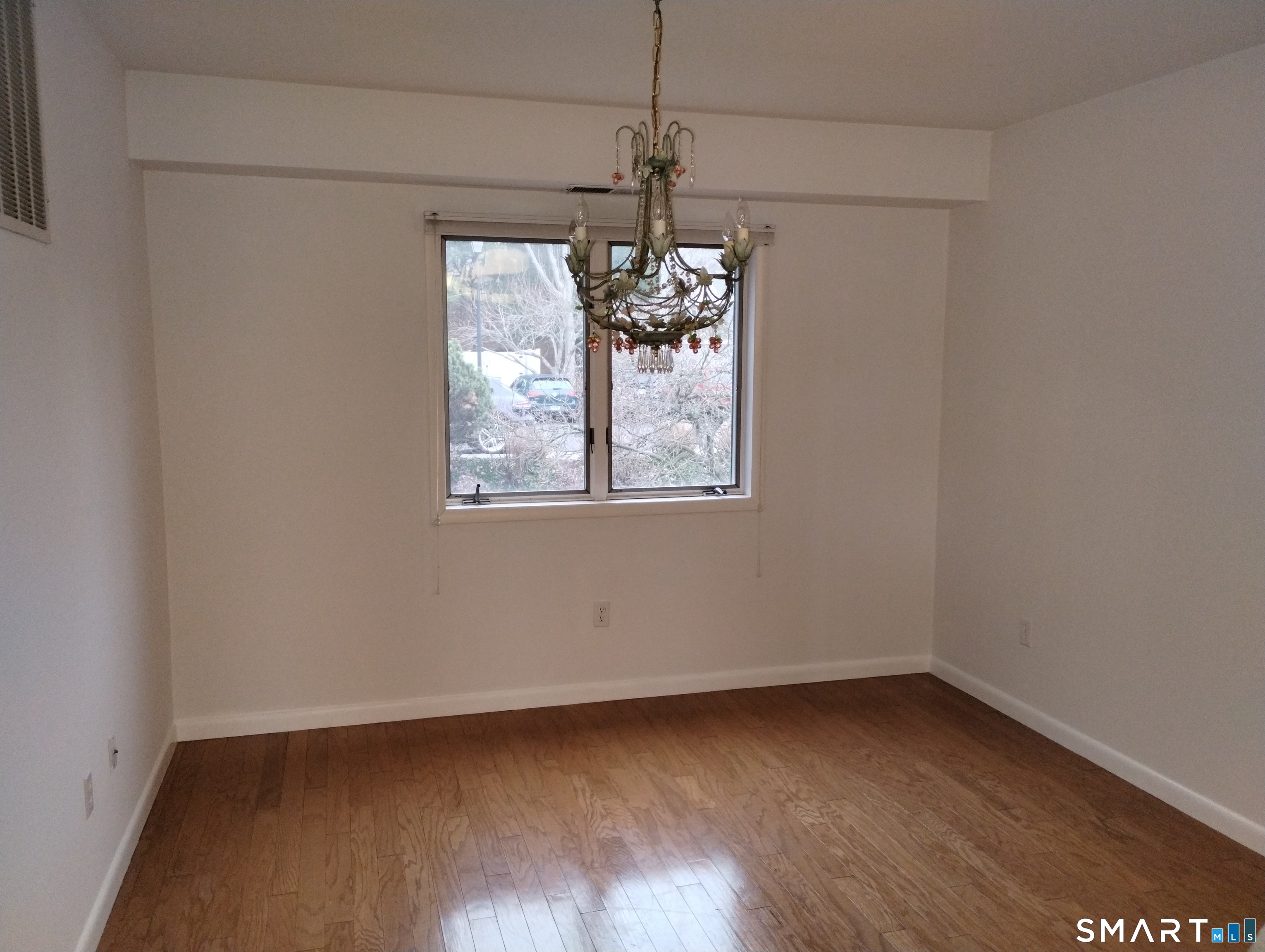 523 Popes Island Road, Unit 523 Milford, CT 06461 - Photo 31 of 33 a view of wooden floor and windows in a room