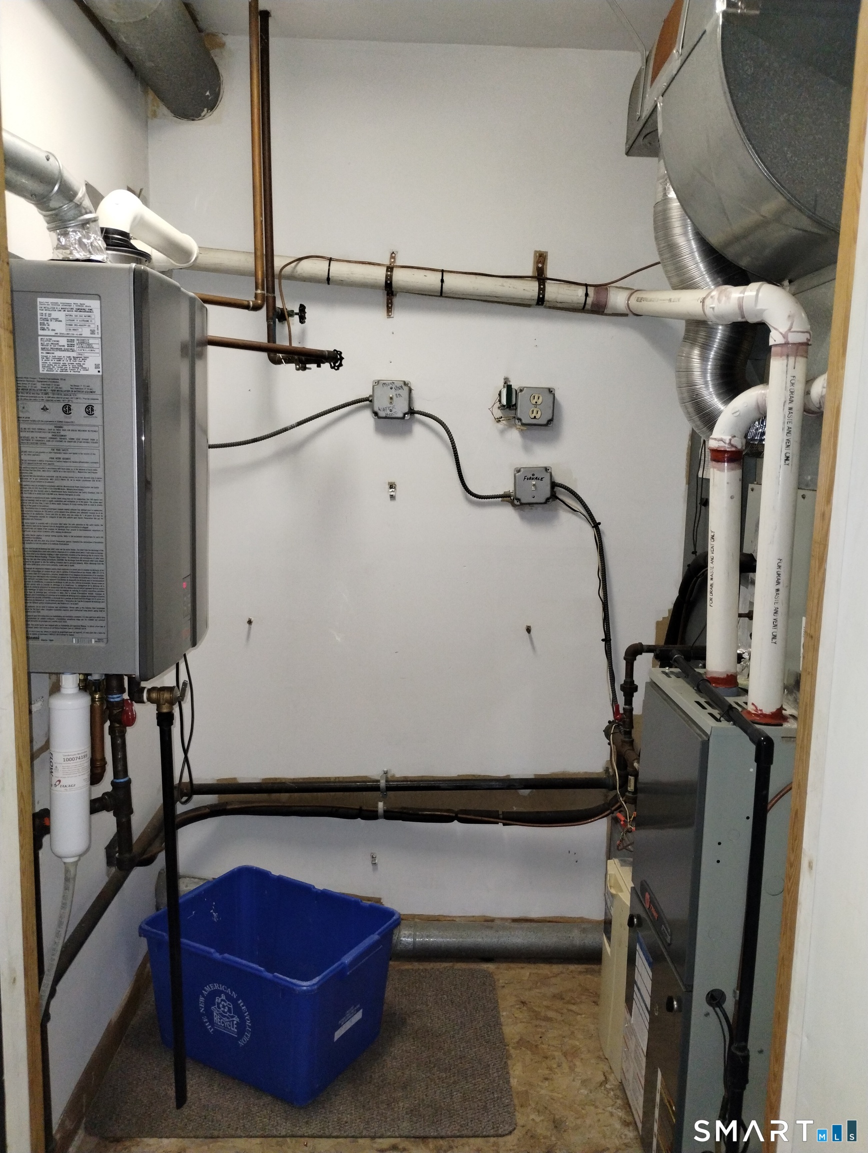 523 Popes Island Road, Unit 523 Milford, CT 06461 - Photo 33 of 33 a room with water heater and wooden cabinets