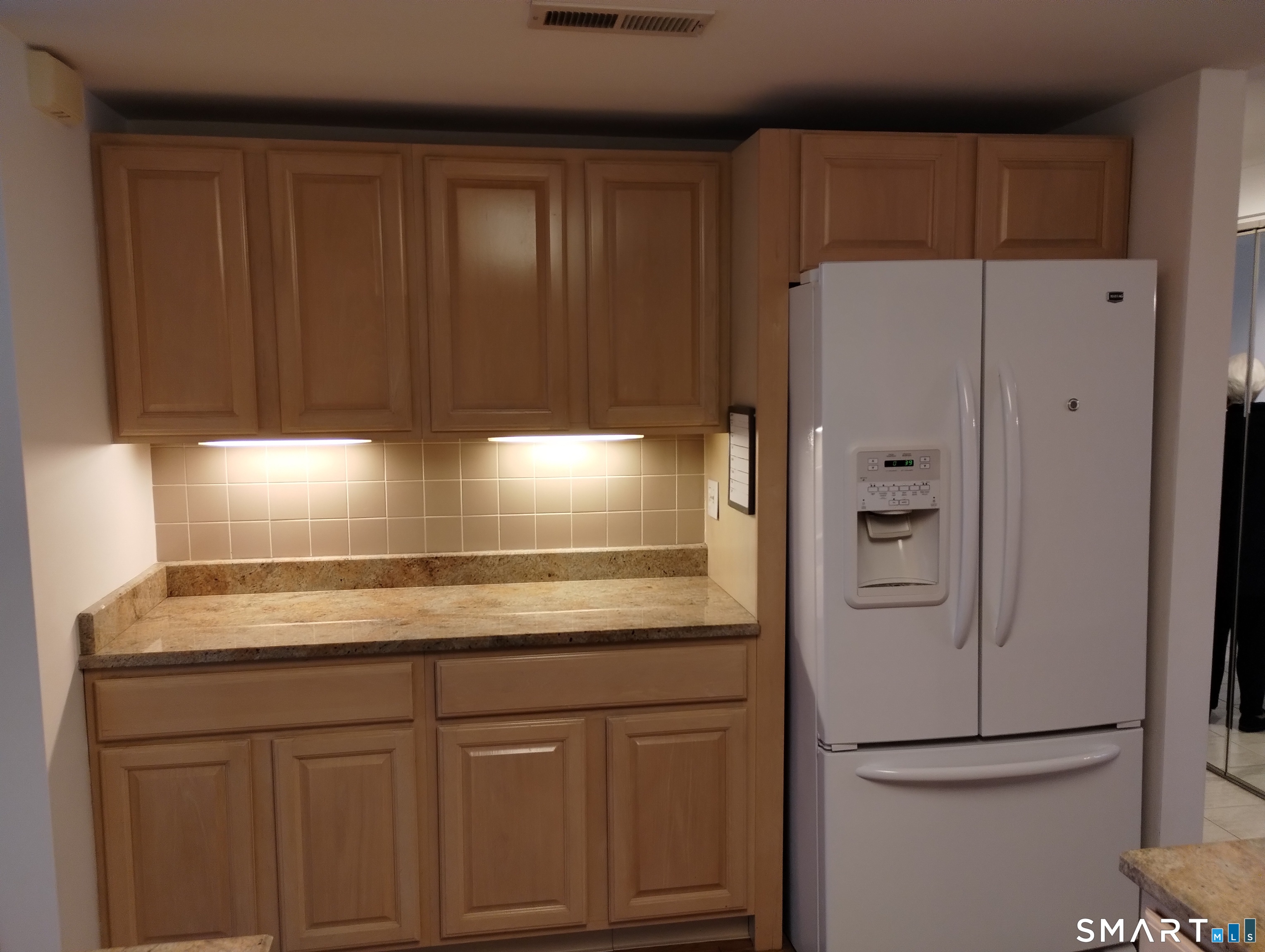 523 Popes Island Road, Unit 523 Milford, CT 06461 - Photo 8 of 33 a view of cabinets and wooden floor