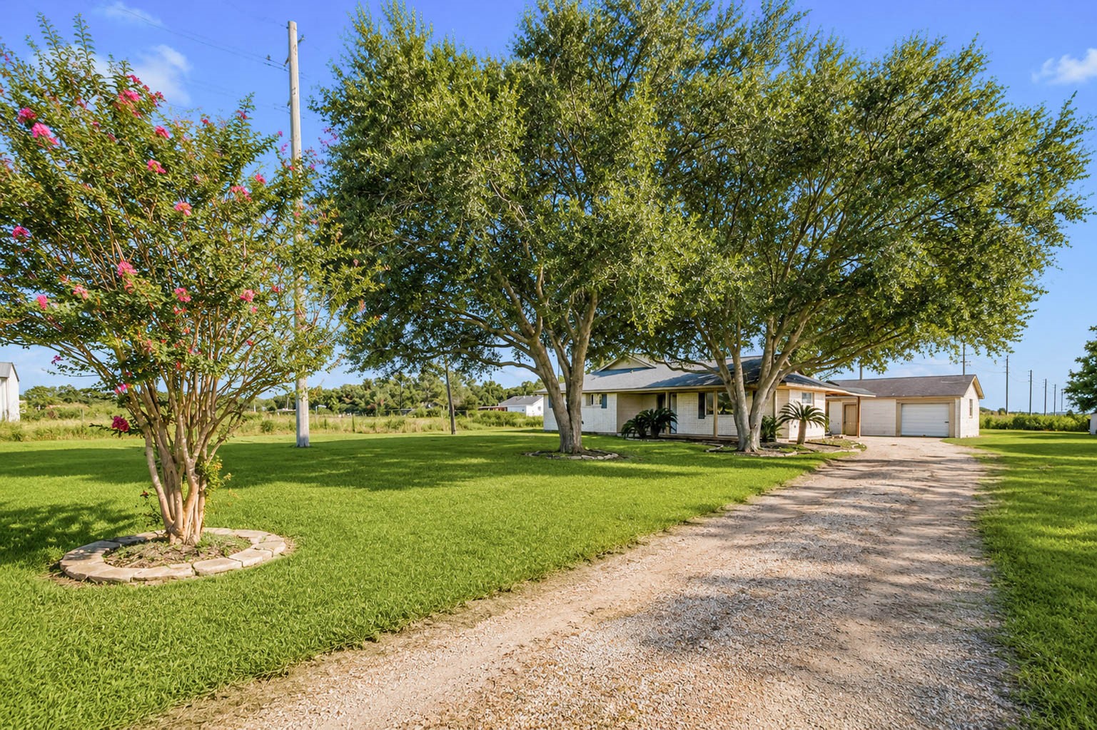 925 Norcross Road Wallis, TX 77485 - Photo 4 of 46 A long gravel drive welcomes you home, winding through beautifully maintained grounds shaded by mature trees. Set on approximately 5 peaceful acres, this inviting country property offers the perfect balance of privacy, open space, and timeless charm.