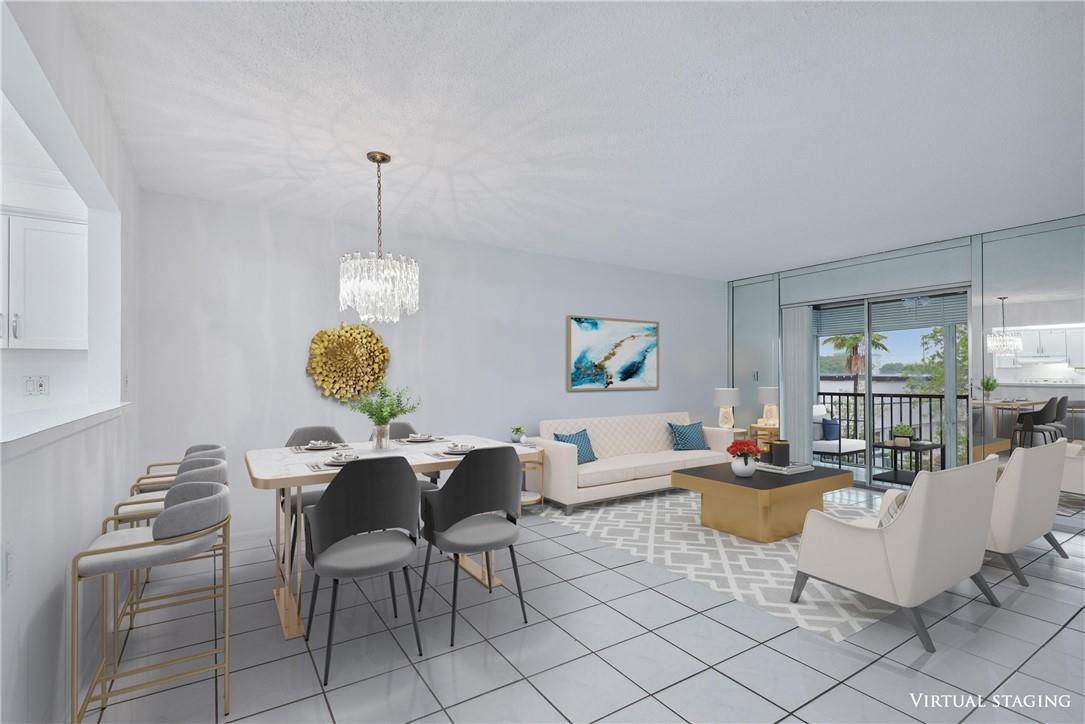 253 South Cypress Road, Unit 234 Pompano Beach, FL 33060 - Photo 1 of 15 a living room with furniture a dining table and a chandelier