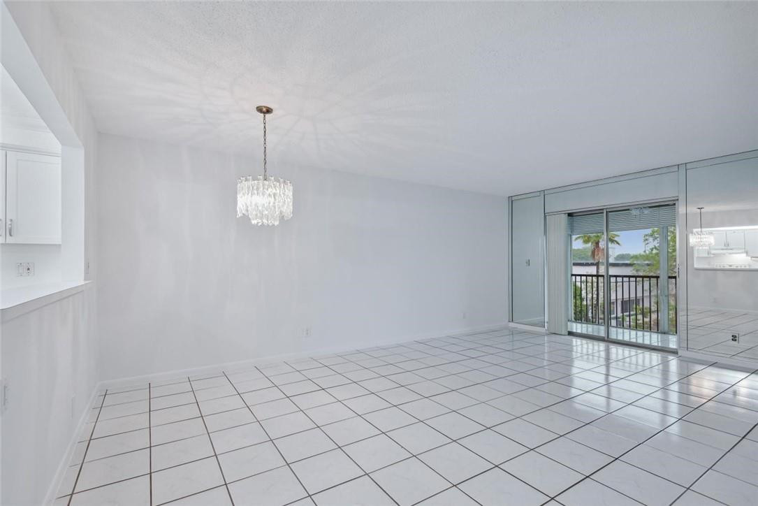 253 South Cypress Road, Unit 234 Pompano Beach, FL 33060 - Photo 12 of 15 a view of empty room with wooden floor