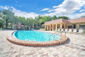 253 South Cypress Road, Unit 234 Pompano Beach, FL 33060 - Photo 4 of 15 a view of a house with a backyard porch and sitting area
