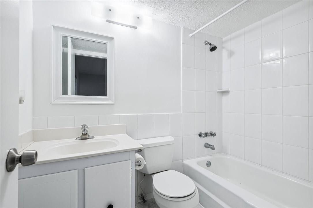 253 South Cypress Road, Unit 234 Pompano Beach, FL 33060 - Photo 7 of 15 a bathroom with a sink a toilet and shower