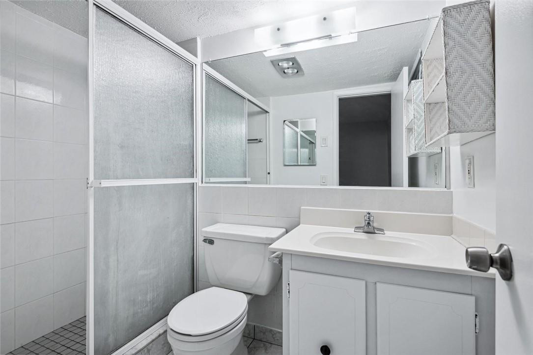 253 South Cypress Road, Unit 234 Pompano Beach, FL 33060 - Photo 10 of 15 a bathroom with a sink toilet and vanity