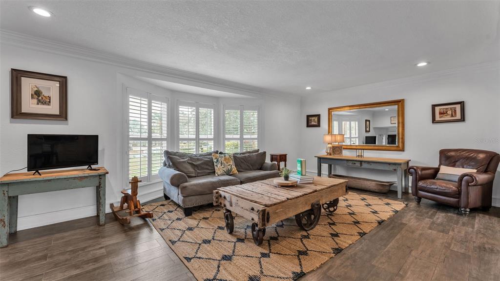 4623 Kings Point Court Lakeland, FL 33813 - Photo 24 of 61 a living room with furniture and a flat screen tv