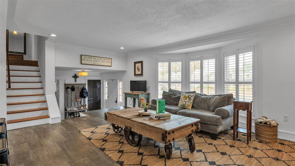 4623 Kings Point Court Lakeland, FL 33813 - Photo 27 of 61 a living room with furniture and wooden floor
