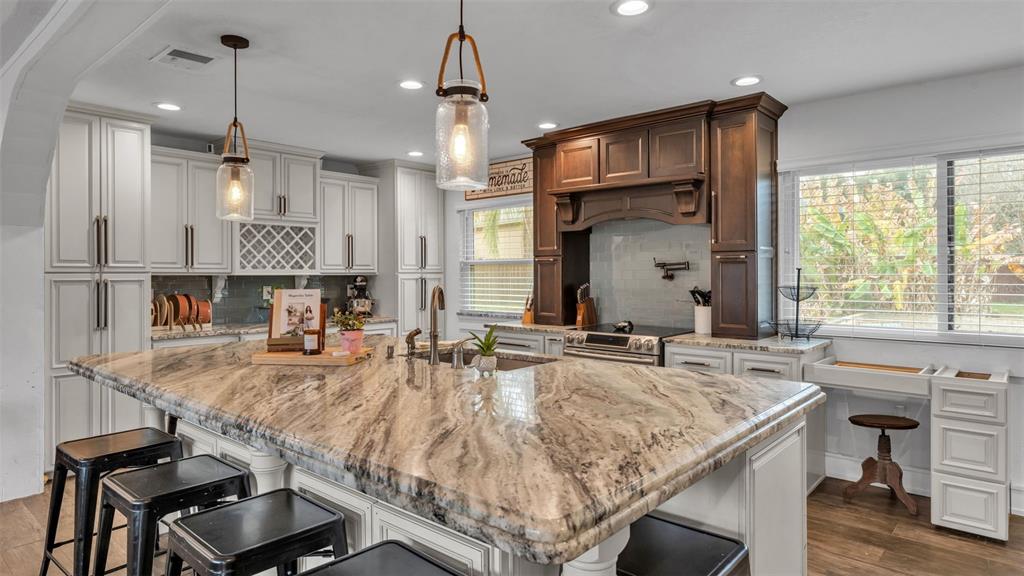 4623 Kings Point Court Lakeland, FL 33813 - Photo 30 of 61 a kitchen with kitchen island granite countertop a sink and a stove