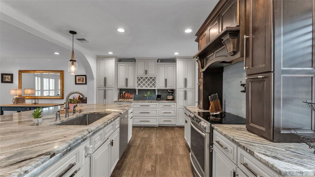 4623 Kings Point Court Lakeland, FL 33813 - Photo 32 of 61 a kitchen with counter top space a sink stainless steel appliances and cabinets