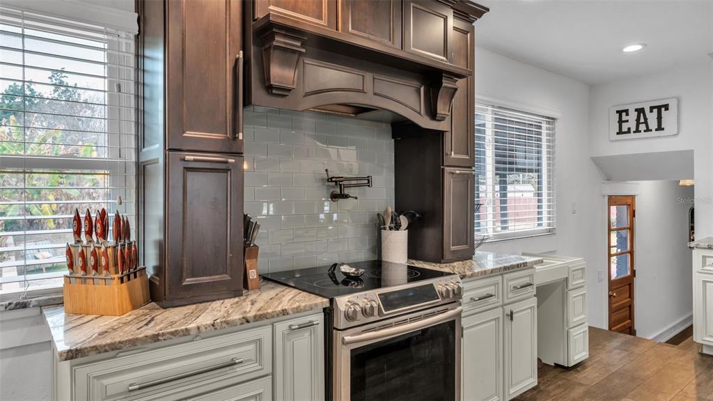 4623 Kings Point Court Lakeland, FL 33813 - Photo 34 of 61 a kitchen with stainless steel appliances granite countertop a stove and a refrigerator