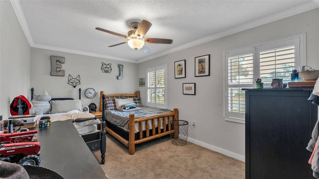 4623 Kings Point Court Lakeland, FL 33813 - Photo 37 of 61 a bedroom with a bed and a chandelier