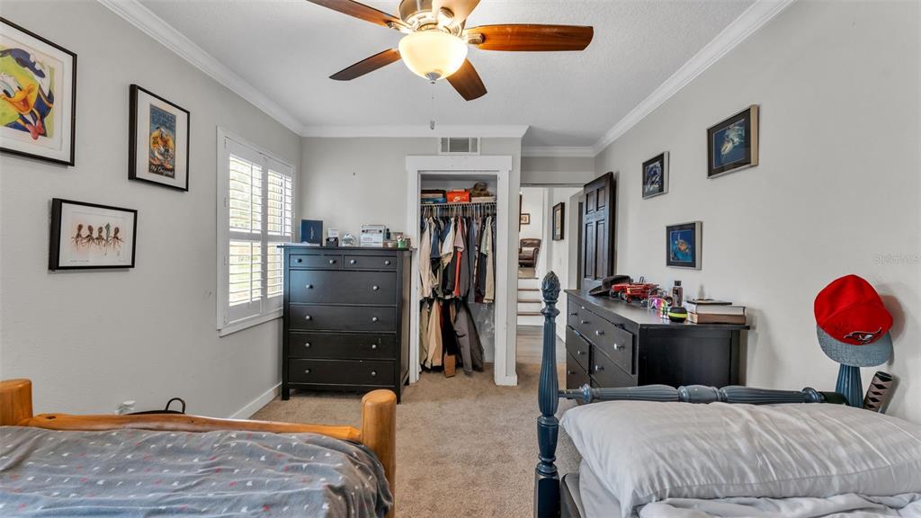 4623 Kings Point Court Lakeland, FL 33813 - Photo 38 of 61 a bedroom with a bed and a chandelier