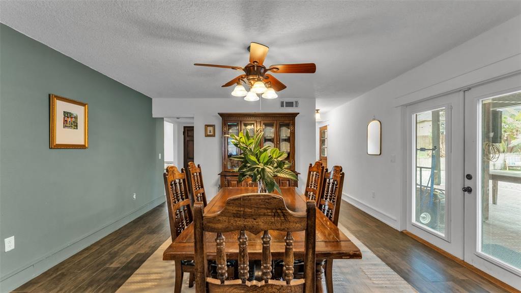 4623 Kings Point Court Lakeland, FL 33813 - Photo 43 of 61 a dining room with furniture a chandelier and wooden floor