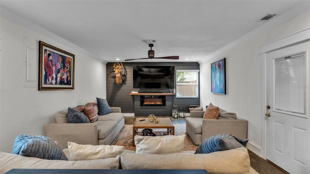 4623 Kings Point Court Lakeland, FL 33813 - Photo 44 of 61 a living room with furniture and a fireplace