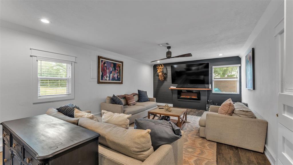 4623 Kings Point Court Lakeland, FL 33813 - Photo 45 of 61 a living room with furniture and a flat screen tv