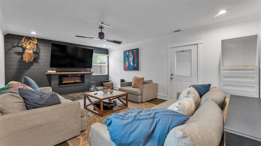 4623 Kings Point Court Lakeland, FL 33813 - Photo 46 of 61 a living room with furniture and a flat screen tv