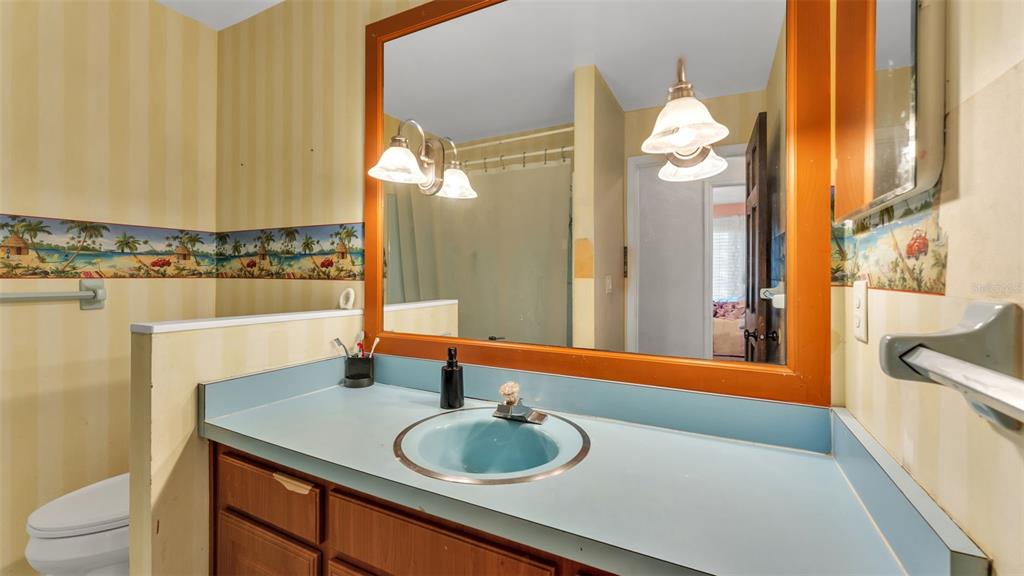 4623 Kings Point Court Lakeland, FL 33813 - Photo 50 of 61 a bathroom with a granite countertop sink and a mirror