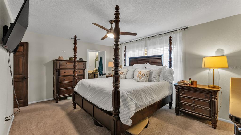 4623 Kings Point Court Lakeland, FL 33813 - Photo 57 of 61 a bed room with a bed and dresser with mirror