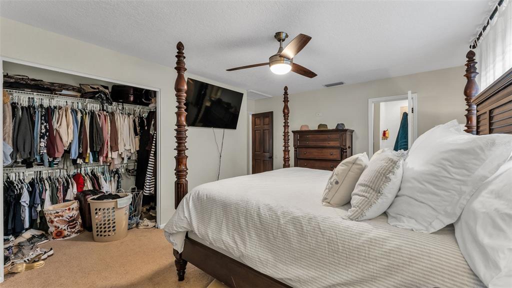 4623 Kings Point Court Lakeland, FL 33813 - Photo 58 of 61 a bedroom with a bed and a flat tv screen