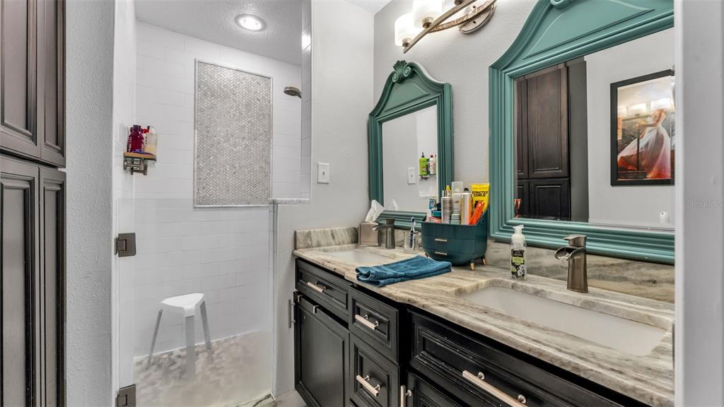 4623 Kings Point Court Lakeland, FL 33813 - Photo 59 of 61 a bathroom with a granite countertop sink a toilet and mirror