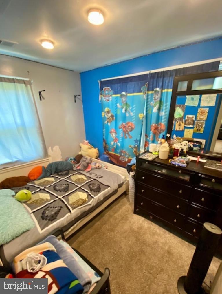 1029 Minnetonka Road Severn, MD 21144 - Photo 8 of 18 a bed room with a bed and a flat screen tv