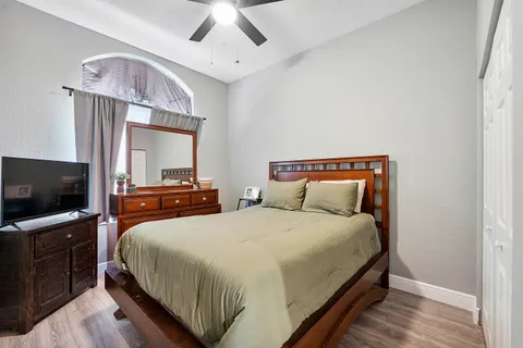 a bedroom with a bed and a flat screen tv
