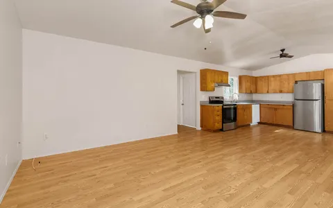 a view of a kitchen with a sink and a refrigerator