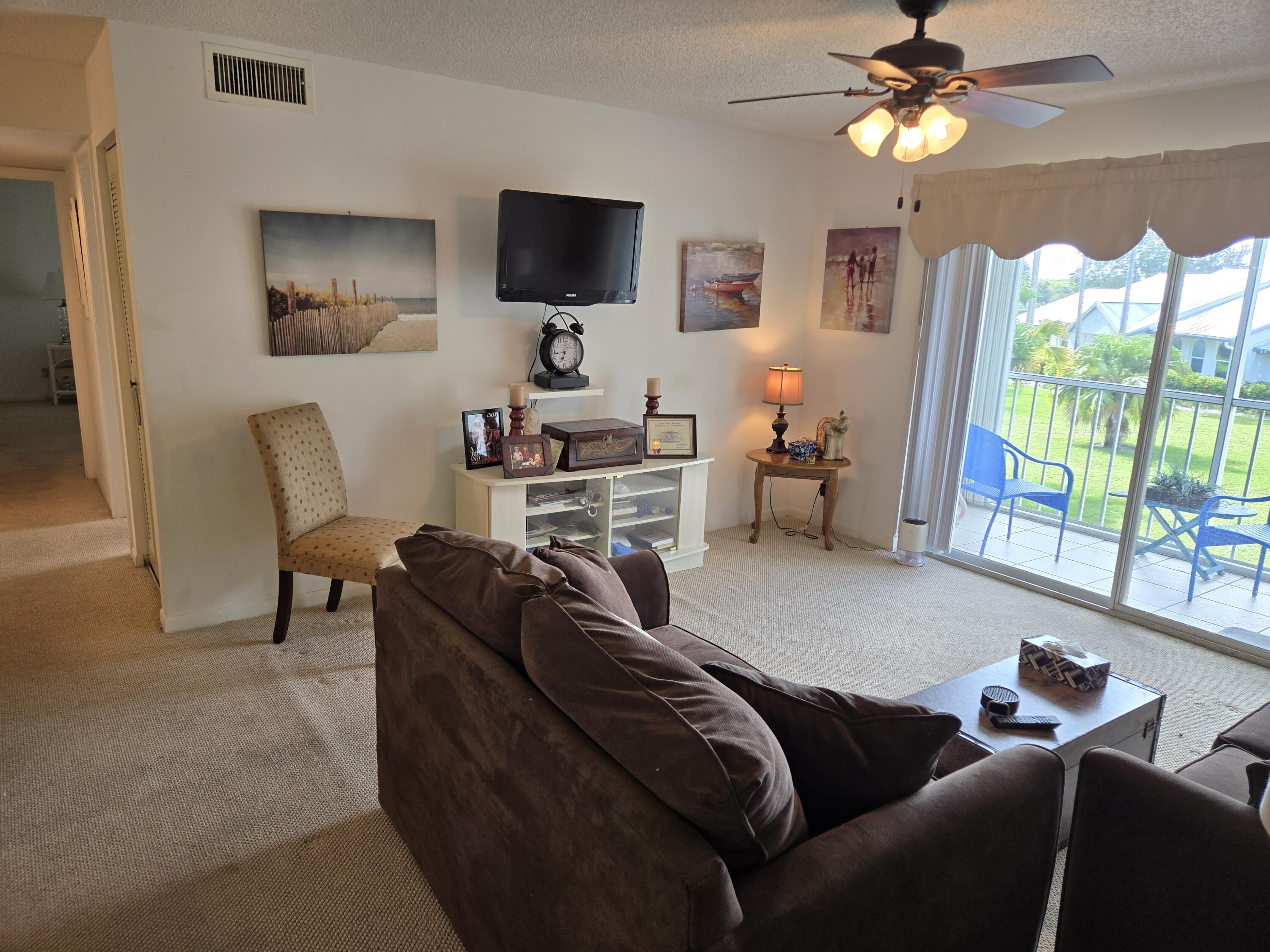 2518 Southeast Anchorage Cove, Unit G2 Port St. Lucie, FL 34952 - Photo 11 of 37 a living room with furniture and a flat screen tv