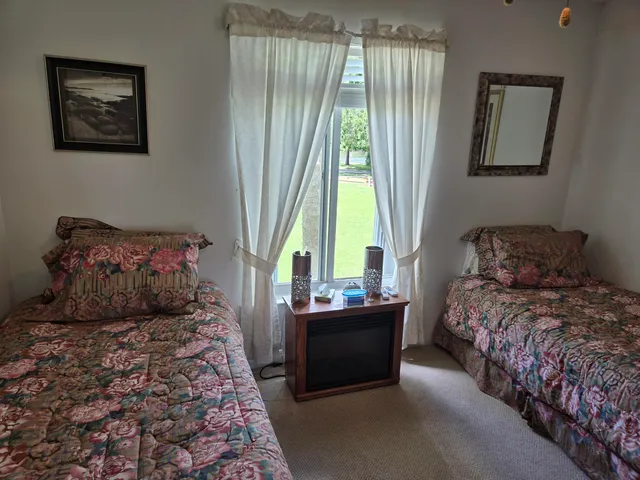 a bedroom with bed and a window
