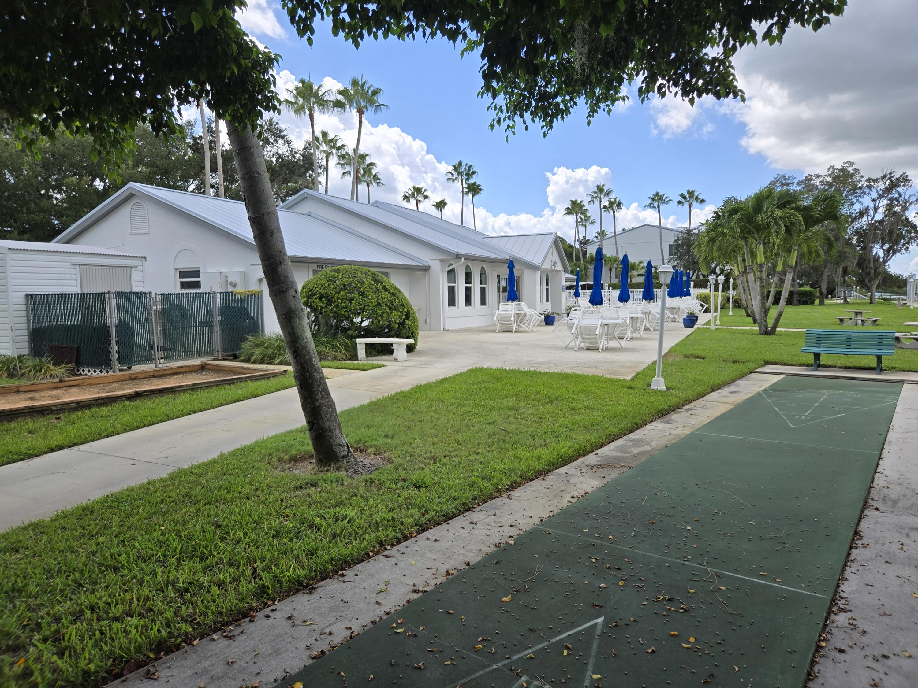 2518 Southeast Anchorage Cove, Unit G2 Port St. Lucie, FL 34952 - Photo 16 of 37 a view of a house with backyard and a tree