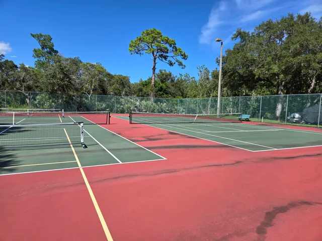 a view of an outdoor space and tennis court