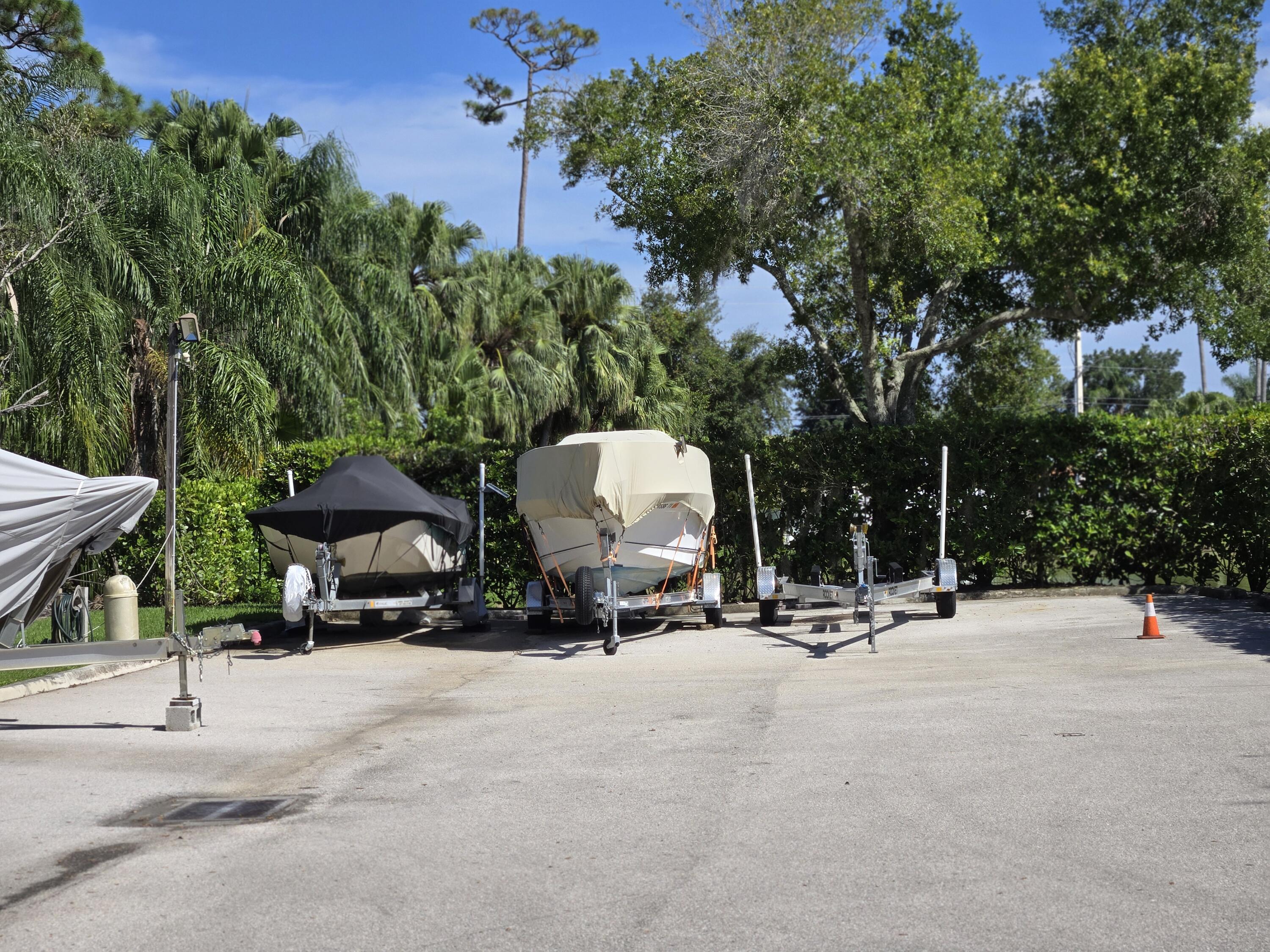 2518 Southeast Anchorage Cove, Unit G2 Port St. Lucie, FL 34952 - Photo 22 of 37 a view of the patio with a bench and trees