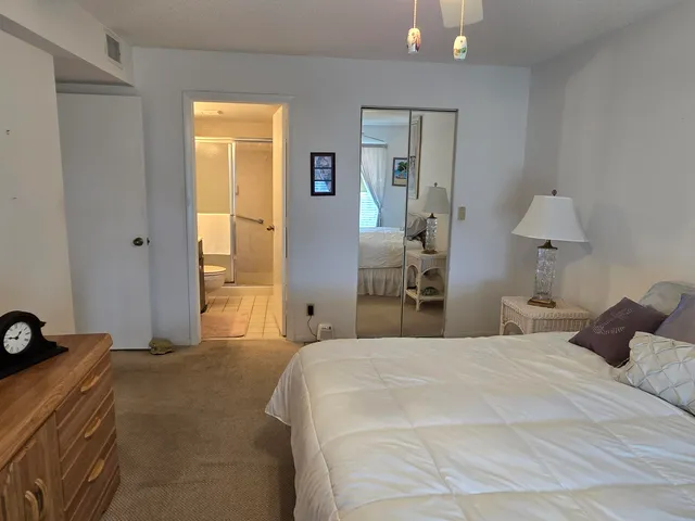 a bedroom with a bed and a lamp