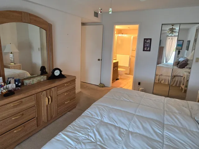 a bedroom with a bed and a dresser in it