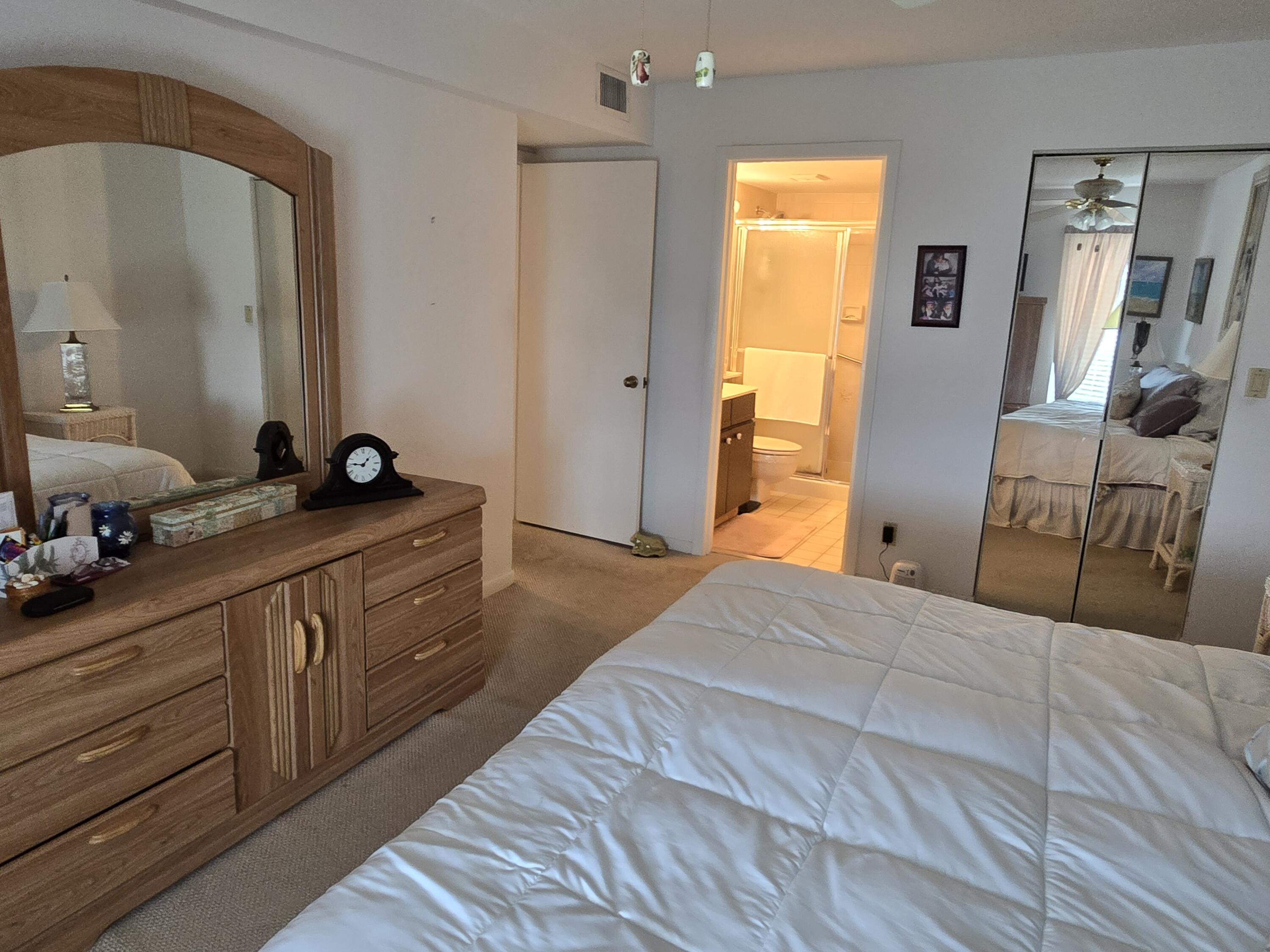 2518 Southeast Anchorage Cove, Unit G2 Port St. Lucie, FL 34952 - Photo 27 of 37 a bedroom with a bed and a dresser in it