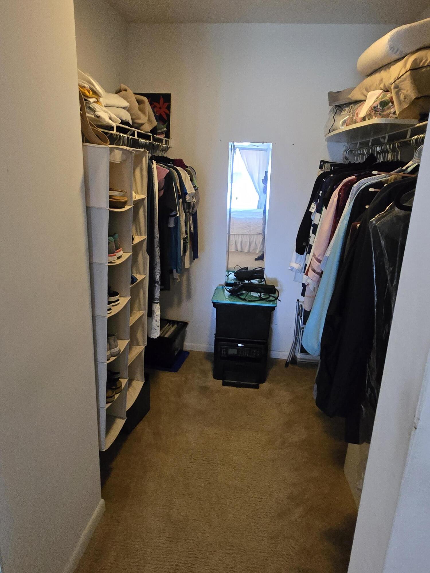 2518 Southeast Anchorage Cove, Unit G2 Port St. Lucie, FL 34952 - Photo 29 of 37 a view of walk in closet with clothes and shoes