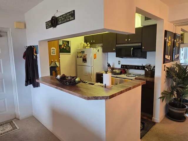 a kitchen with a sink appliances and cabinets