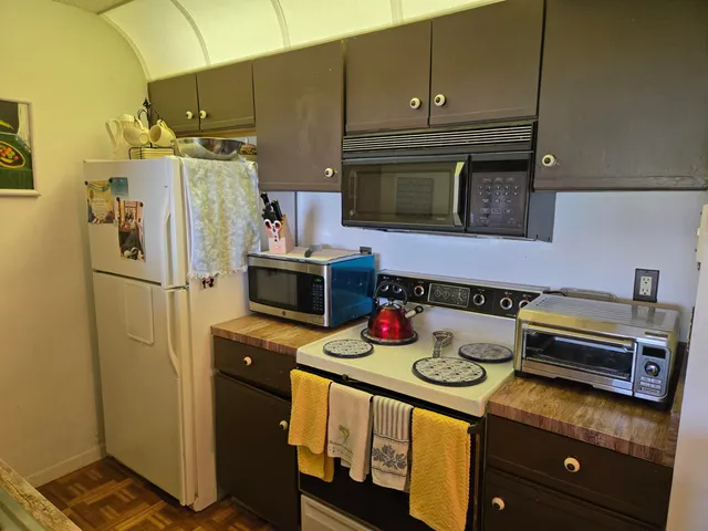 a kitchen with appliances cabinets and a counter top space