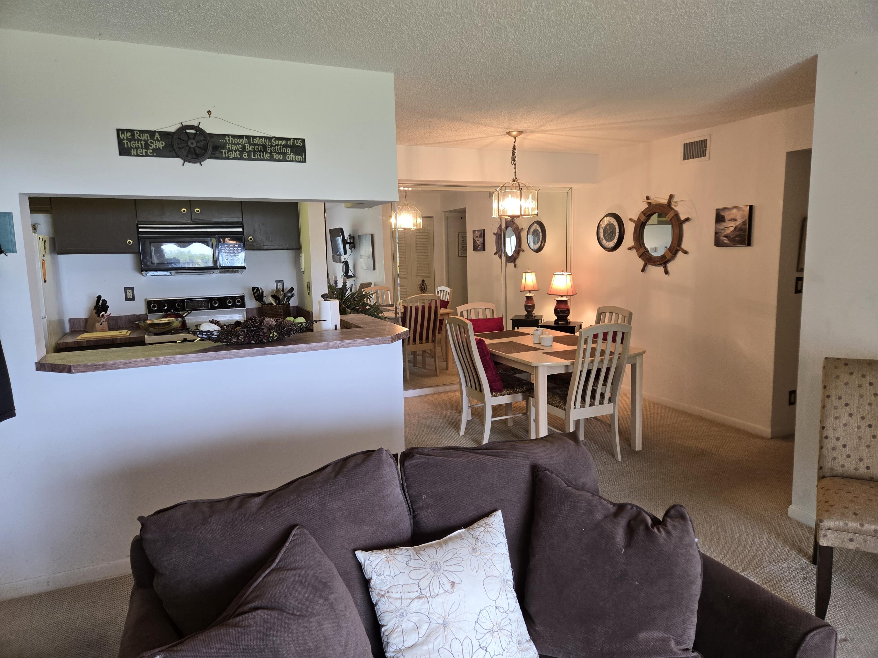 2518 Southeast Anchorage Cove, Unit G2 Port St. Lucie, FL 34952 - Photo 7 of 37 a dining room with furniture and wooden floor