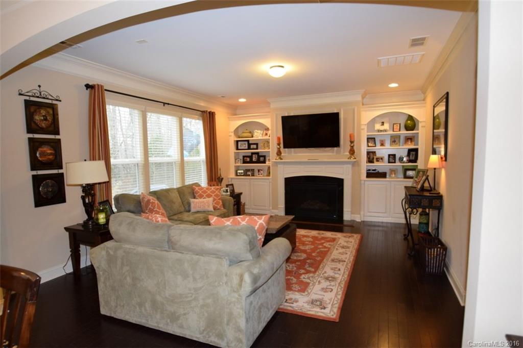 3034 Fallondale Road Waxhaw, NC 28173 - Photo 11 of 22 a living room with furniture a flat screen tv and a fireplace
