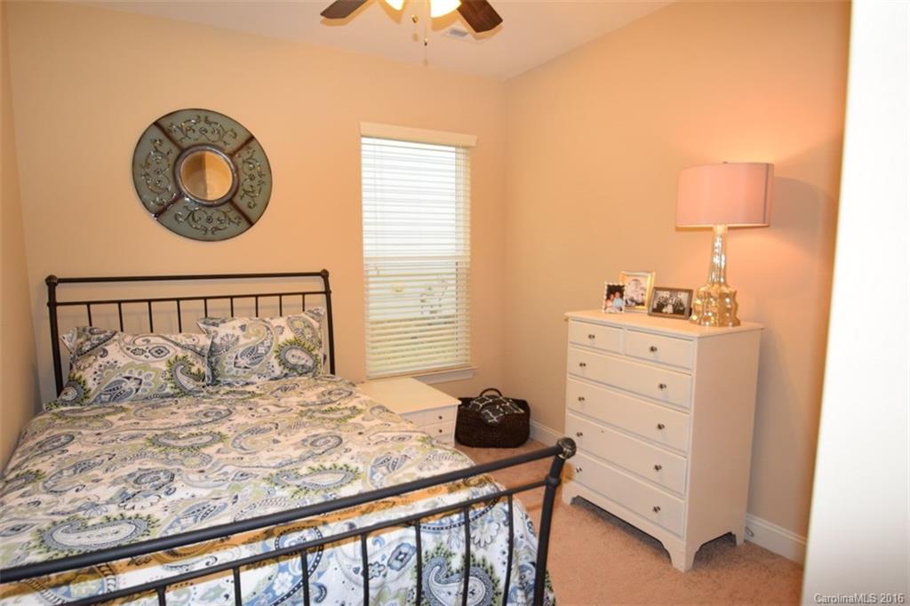 3034 Fallondale Road Waxhaw, NC 28173 - Photo 12 of 22 a bedroom with a bed and a lamp on dresser