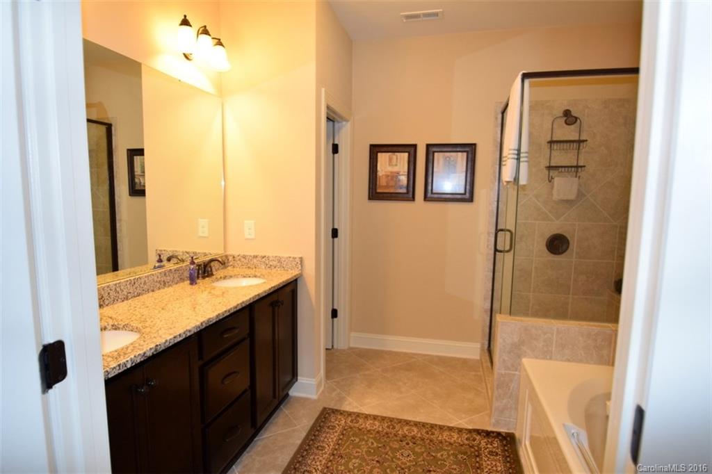 3034 Fallondale Road Waxhaw, NC 28173 - Photo 15 of 22 a bathroom with a granite countertop tub sink and mirror