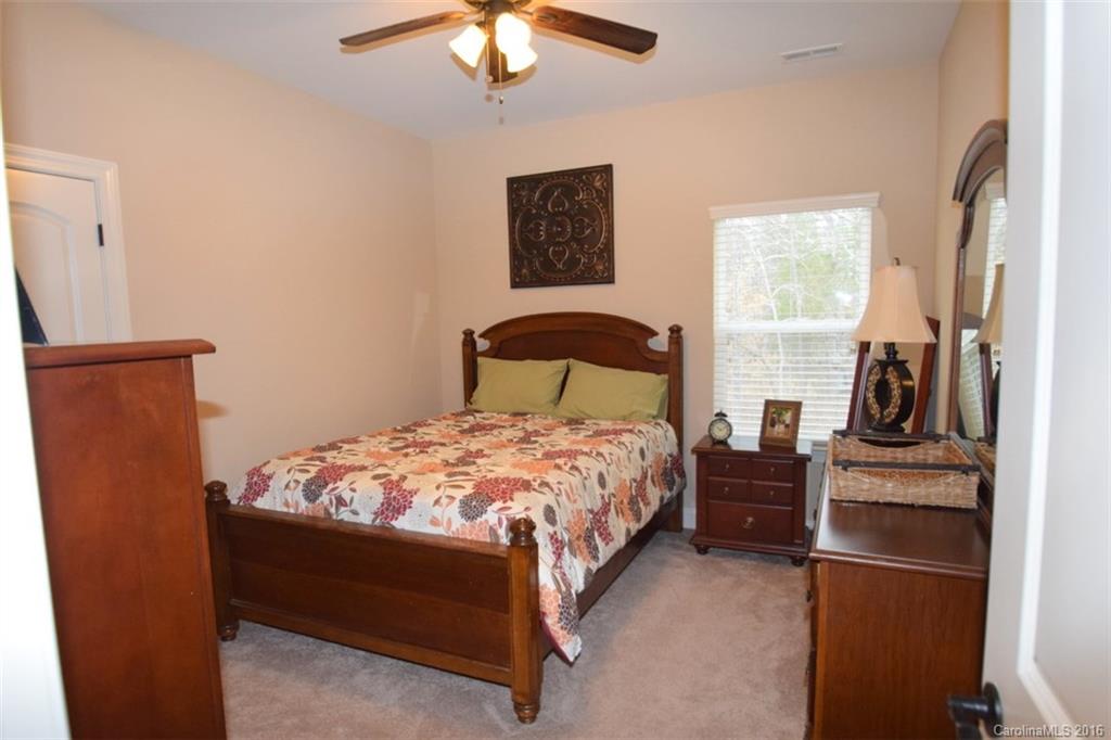 3034 Fallondale Road Waxhaw, NC 28173 - Photo 19 of 22 a bedroom with a bed and a chandelier
